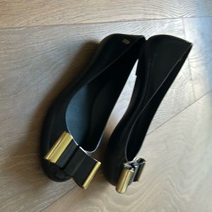 Gently worn Melissa jelly flats with gold black bow including dust bag